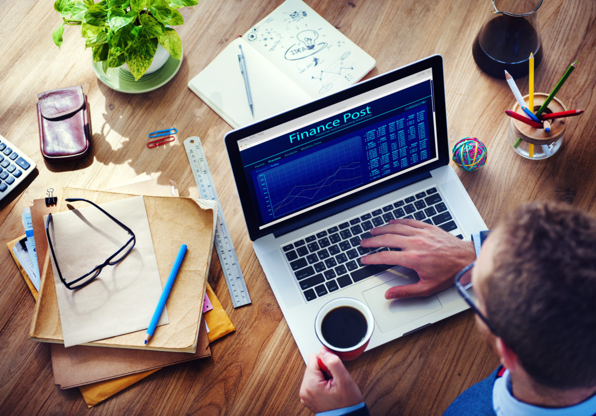 Abstract image of man with coffee viewing a website on his laptop